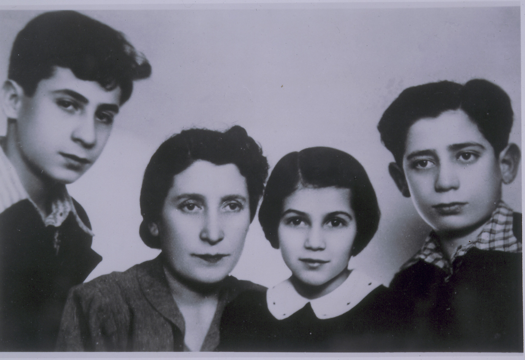 Photograph of Hela Berkowicz and her children Henryk, Noemi and Bernard taken in Warsaw and sent to Hela's husband Lejba Berkowicz in Vilna.  All four were later killed in Treblinka.
