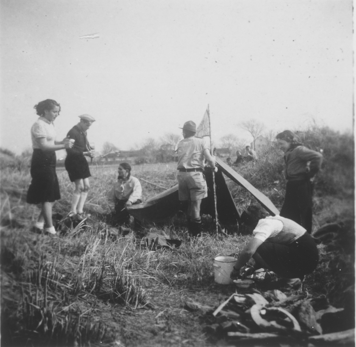 Jewish scouts set up a tent and prepare a meal during a camping trip to the Hunjow cemetery in Shanghai.

Among those pictured is Guenther Matzdorff.