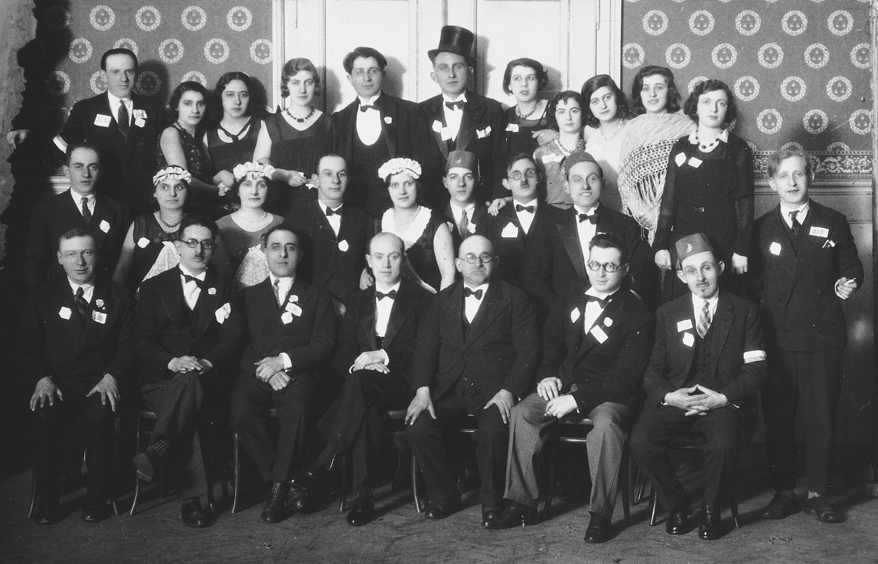 Group portrait of French Jews celebrating Purim in formal attire and costumes in Strasbourg.

Among those pictured is Sabina Findling (top row, third from left).