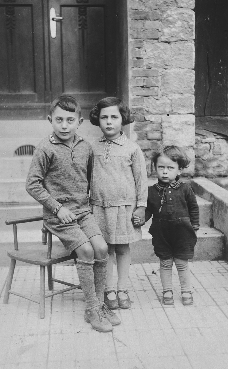 Three German-Jewish siblings pose outside their home in Rimbeck, Germany.

Pictured are Werner, Inge, and Ludwig Fischel.