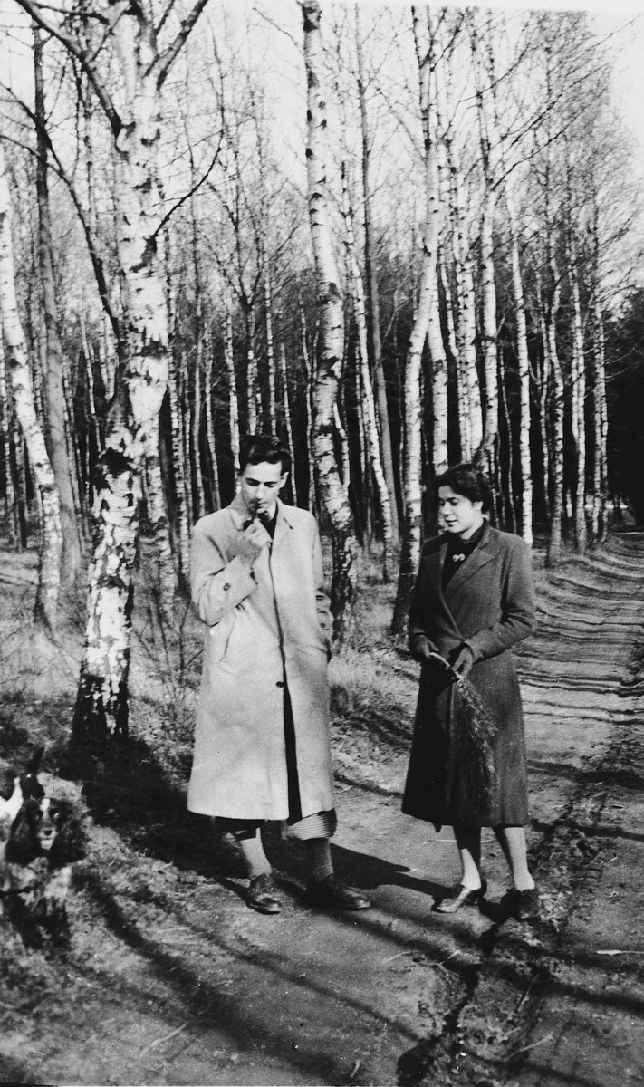 Irene Spicker, a German-Jewish refugee, walks through the woods with a Belgian friend, Jules Bicholf.