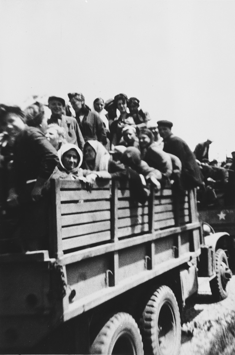 Hungarian-Jewish survivors of a concentration camp near Homberg, Germany depart the camp on board a convoy of trucks.

These women were liberated from soldiers from the 6th Armored Division.