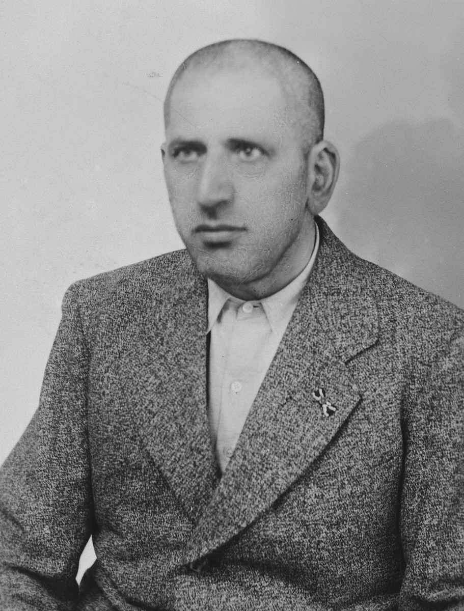 Close-up portrait of a German-Jewish man with a shaved head shortly after his release from four weeks in the Buchenwald concentration camp.

Pictured is Siegfried Fischel.