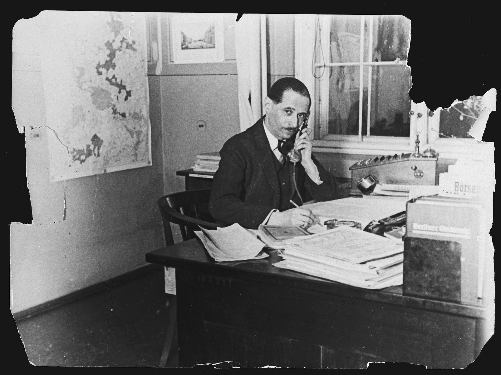 Kurt Zielenziger answers the phone at his desk in the Berlin city hall where he was working as press secretary to the mayor.