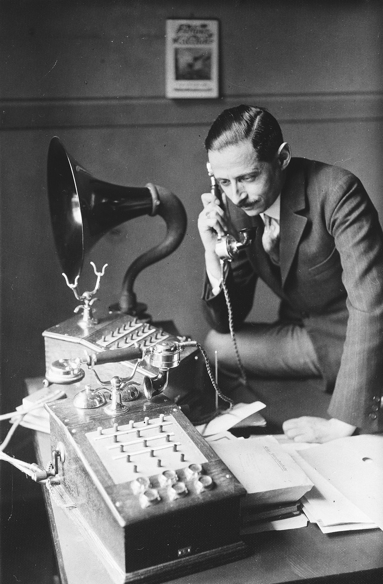 Kurt Zielenziger answers the phone at his desk in the Berlin city hall where he was working as press secretary to the mayor.