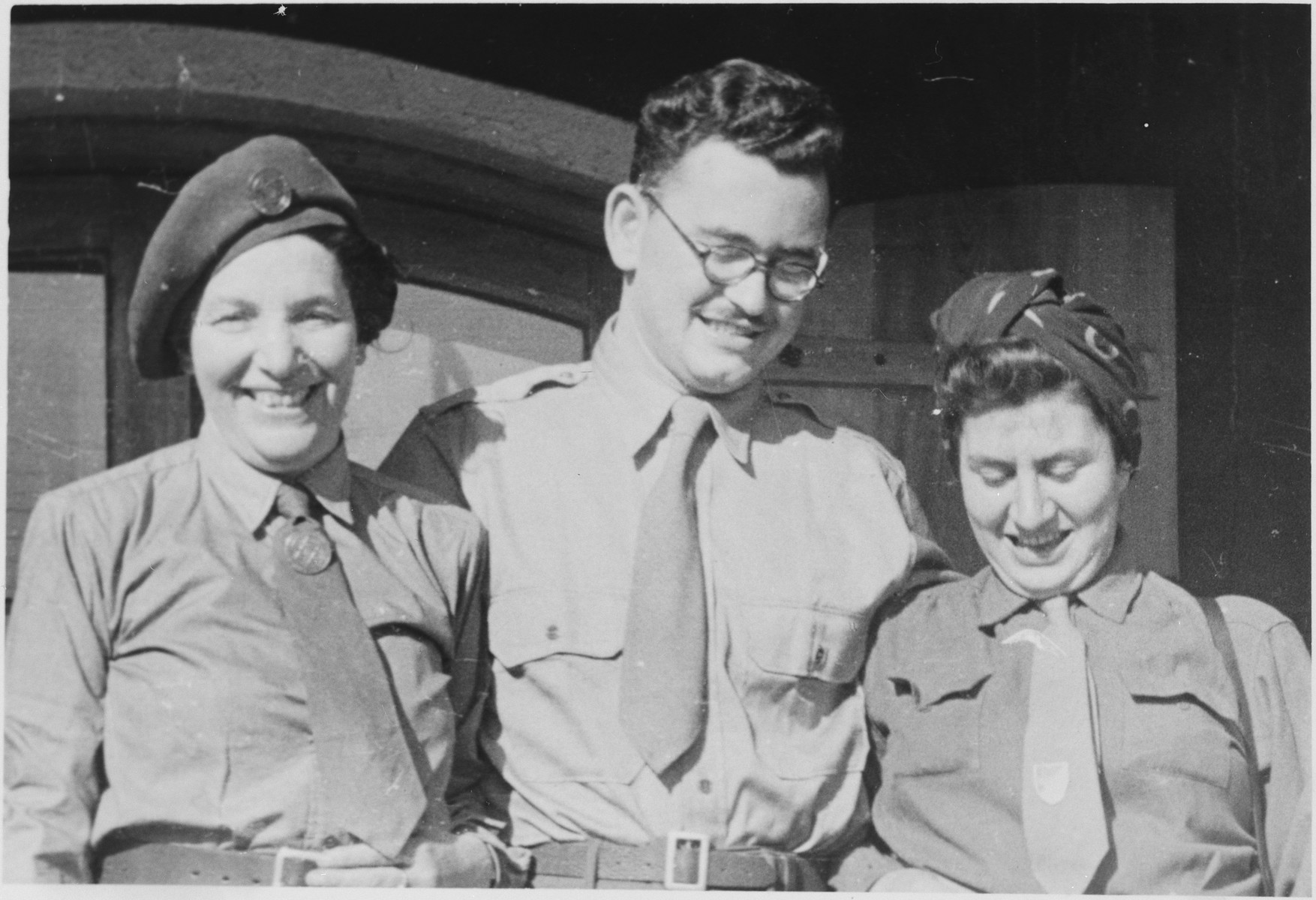 Close up portrait of three UNRRA workers in the Windsheim displaced persons' camp.

Stanley Abrmowitz is pictured in the center.