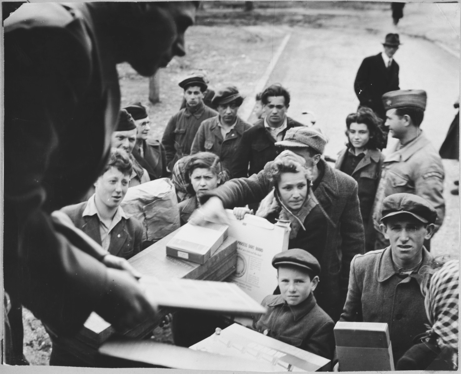 Relief workers in the Foehrenwald displaced persons' camp unload supplies from a truck.