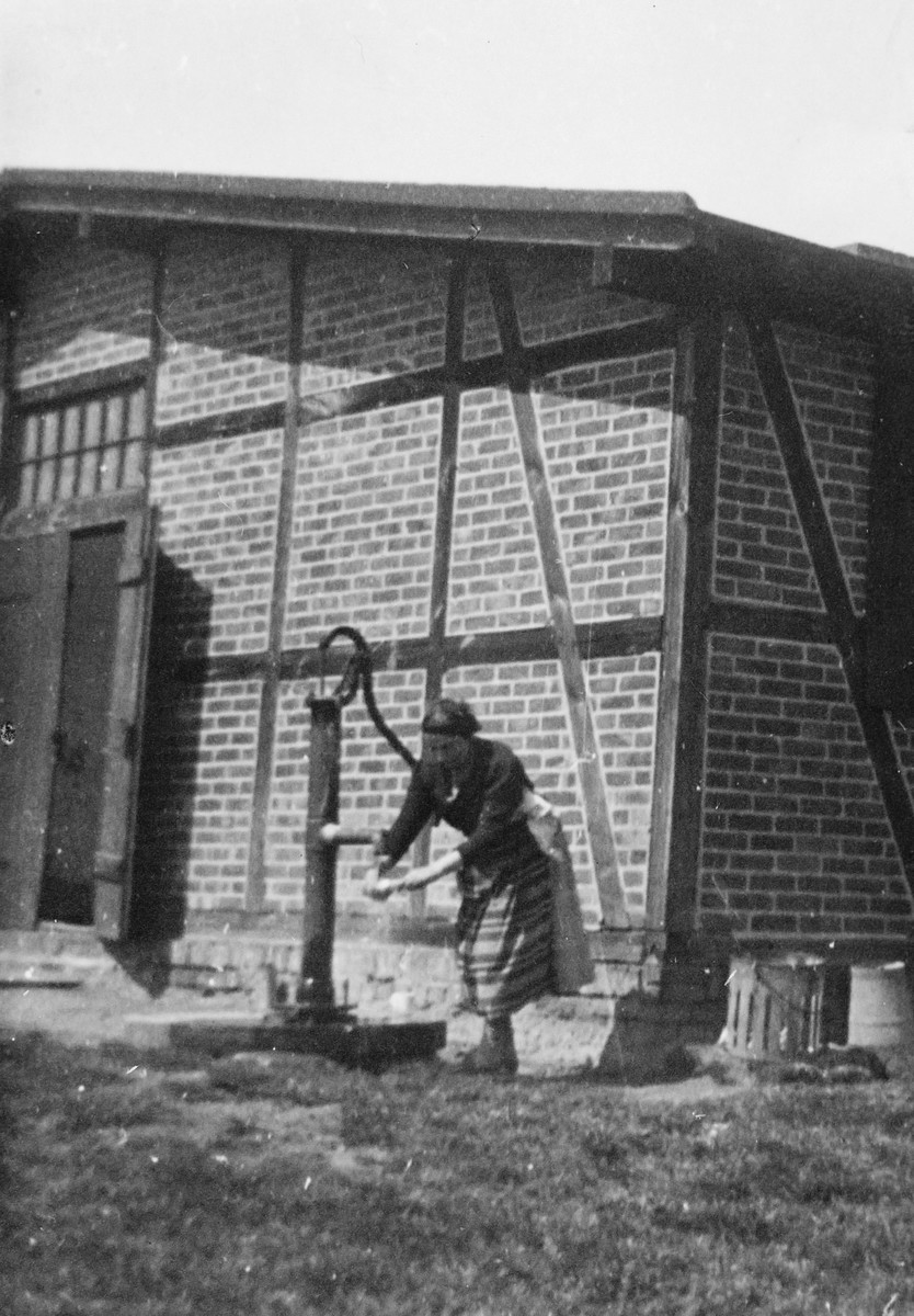 A Jewish forced laborer pumps water in a farm in Osterburg, Germany.