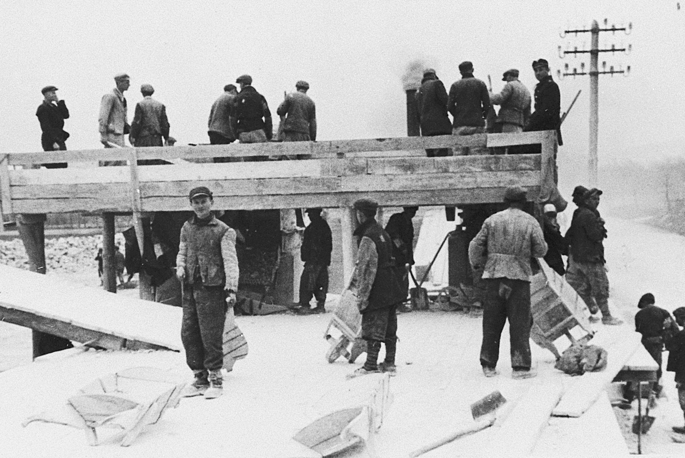 Jewish prisoners from the Stupki labor camp at forced labor in a quarry. 

Stupki was one of several labor camps established along the route of the Rollbahn Sued in Galicia.

Pictured in the foreground, facing the camera, is Moshe Kohn.