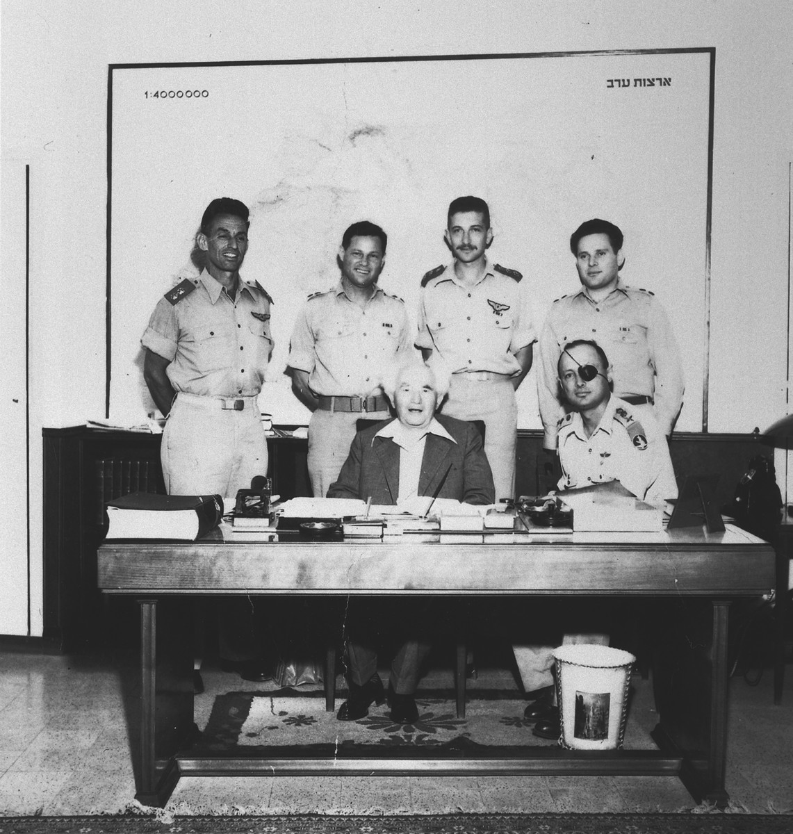 Prime Minister David Ben-Gurion and General Moshe Dayan pose with members of the Israeli Armed Forces.

Standing from left to right are Geda Shochet, Yossi Harel, Ezer Weizman and Nachman Karni, spokesman for the Israeli Defense Force from 1952-1954.
