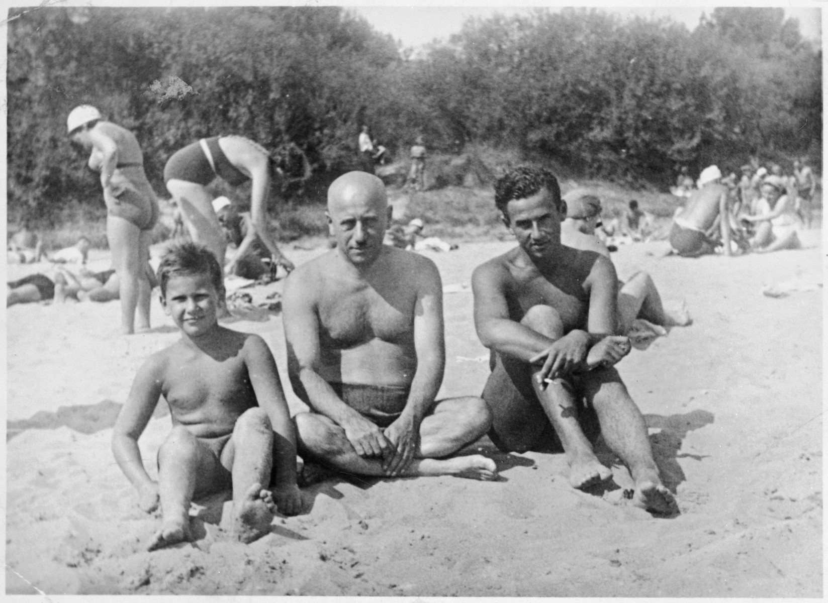 A Jewish father with his two sons at Niemen Beach in Grodno, Poland.

Pictured are Alexander Blumstein (far left), Chaim Blumstein (middle) and Nataniel "Tolo" Blumstein (right).