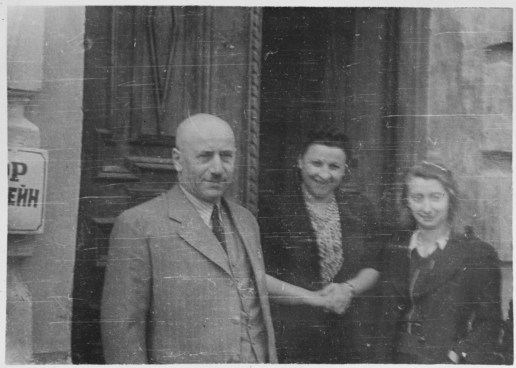 Jewish married couple standing with their niece outside of their home in Grodno, Poland.

Pictured are Chaim and Estera Blumstein and their niece Lenka.