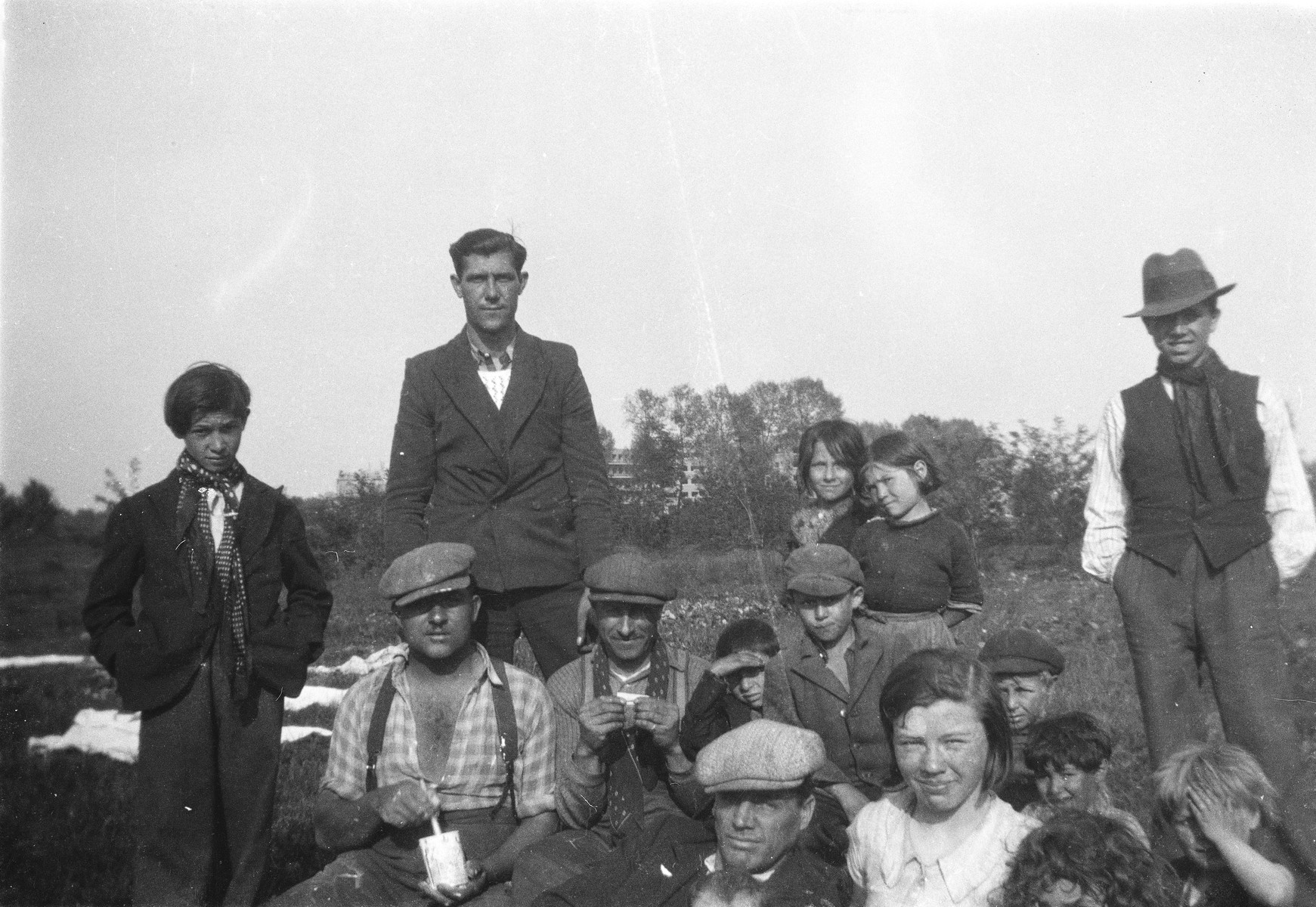 A Romani family poses for an outdoor photograph.