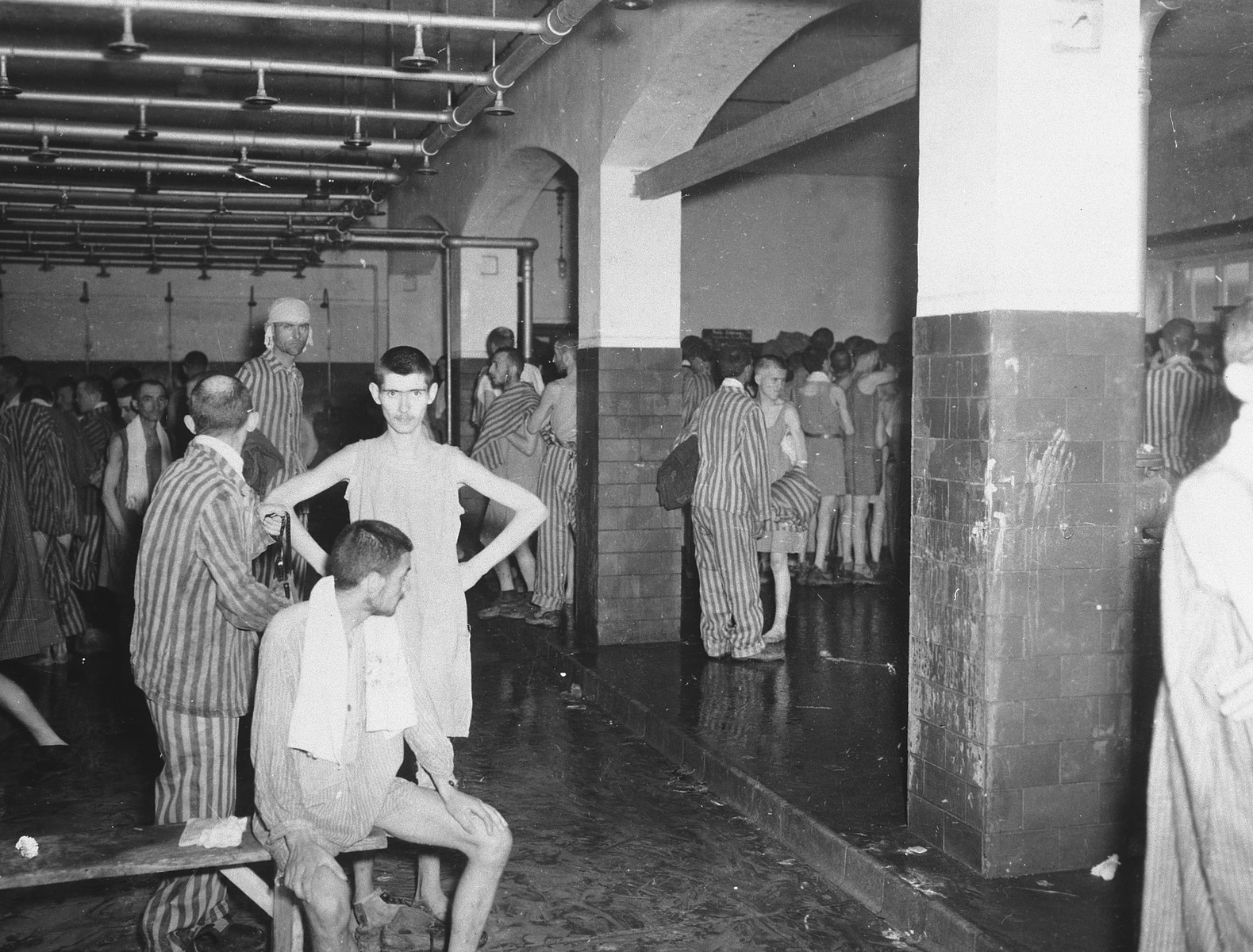 Survivors in the shower barracks after liberation.
