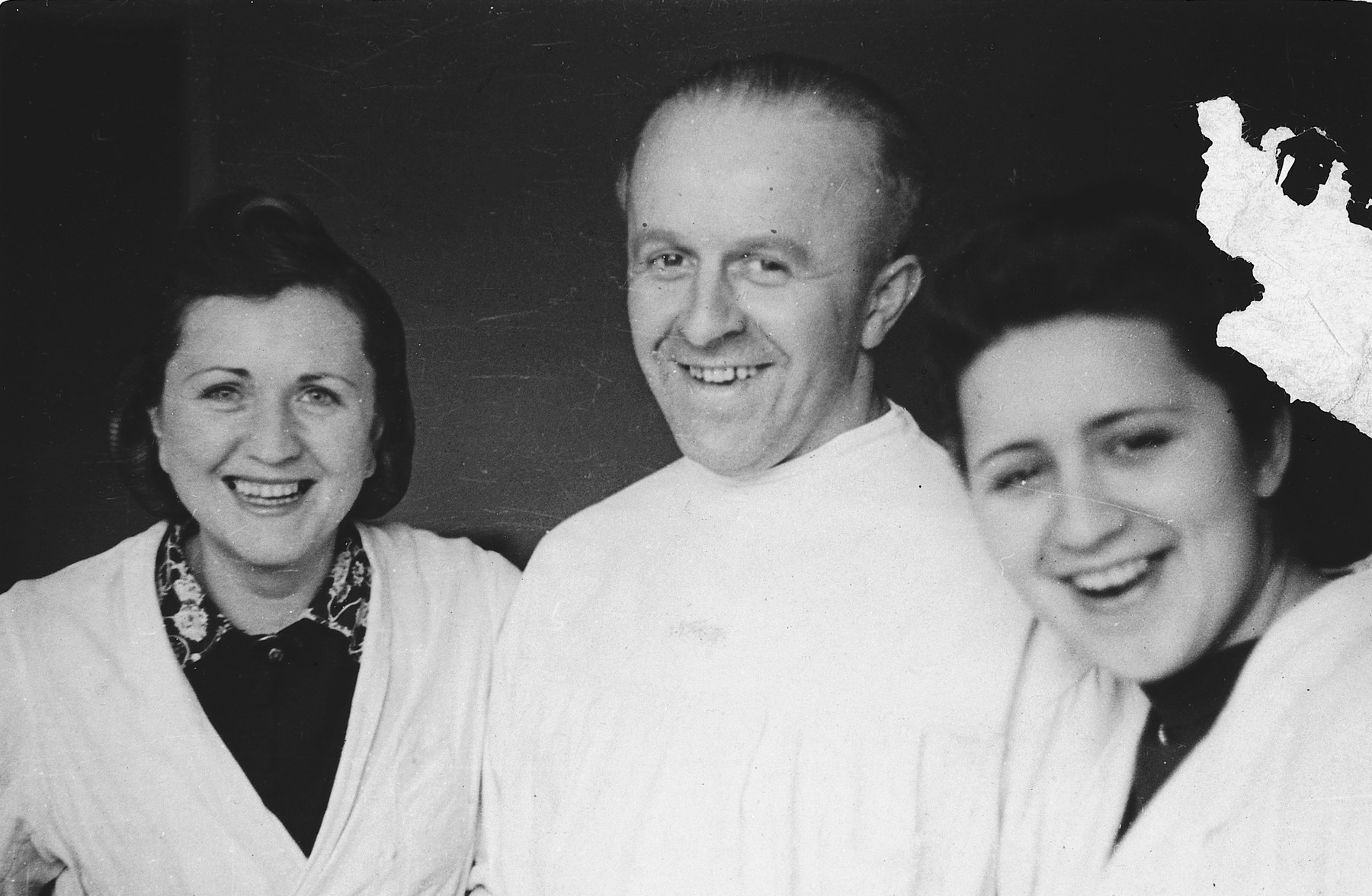 Lala Grunfeld poses with a Nazi dentist and another dental technician while hiding as a Polish woman in Warsaw.