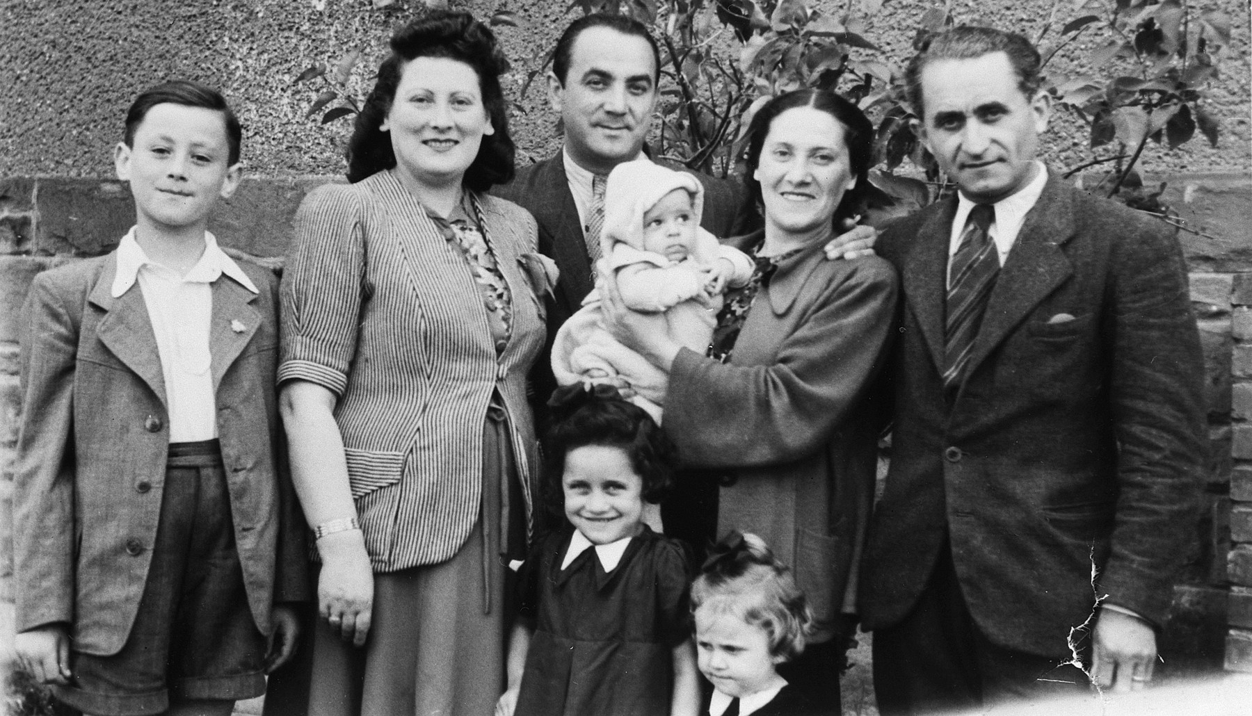 Portrait of an extended Jewish family in the Stuttgart displaced person's camp.

Pictured from left to right are Lova Warszawczyk and his parents, Masha and Josef Warszawczyk, Josef's brother Nathan Warszawczyk, his wife Chana holding her baby Baruch, and daughters Mira and Zilla .