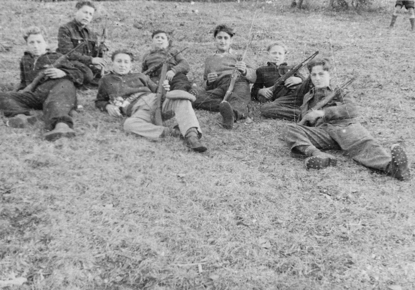 Teenage boys lie in the grass holding weapons during paramilitary training in the Selvino children's home.

The boys were issued real weapons, Italian 22 caliber guns with attached bayonets, but no ammunition.