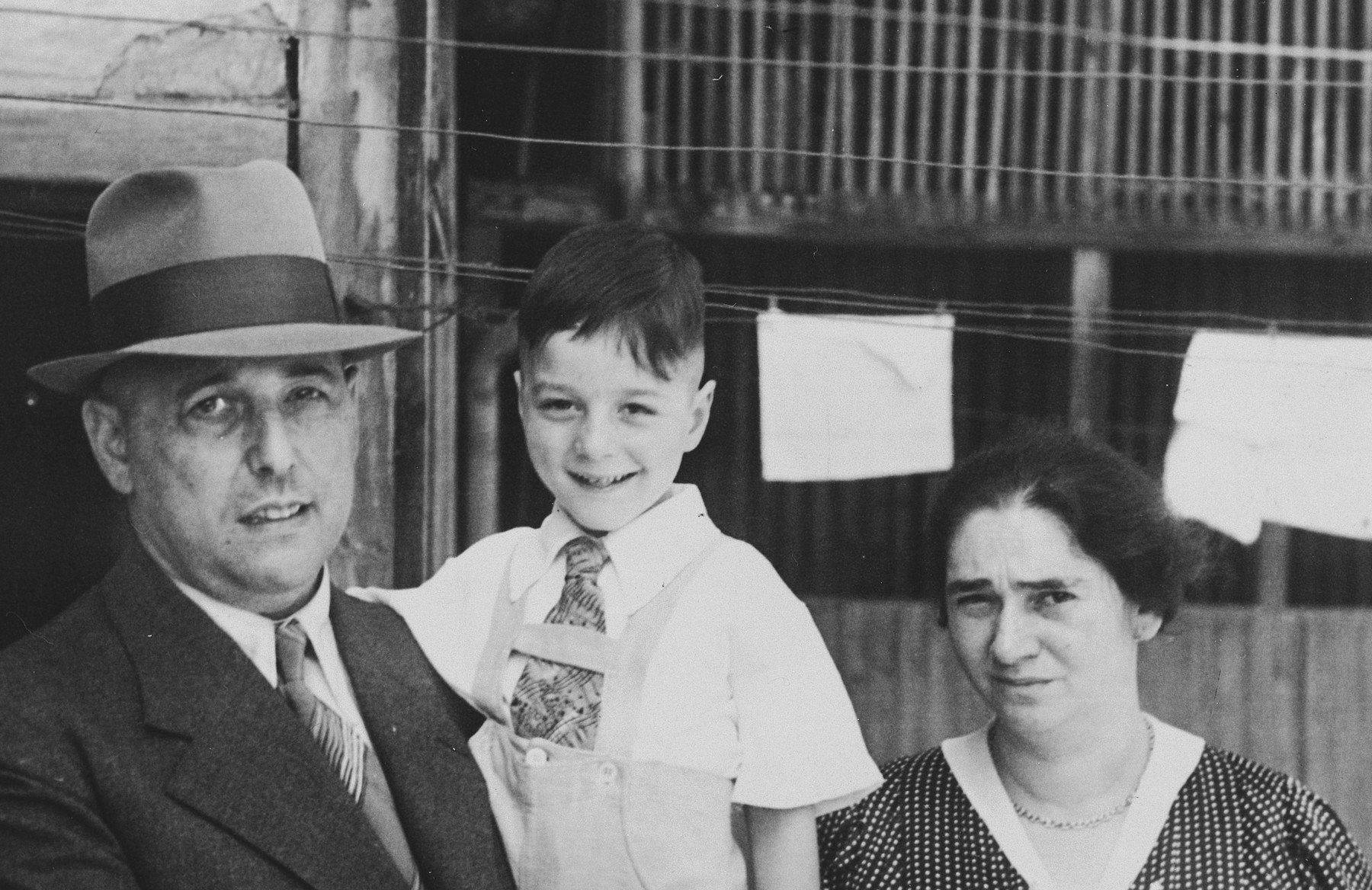 Close-up portrait of a Jewish family in Breisach, Germany.

Pictured are Hugo, Arno and Hulda Geismar.  Hulda was born on July 7, 1899.  Hugo was born in Breisach on March 27, 1890.  Arno was the last Jewish child to be born in Breisach in 1932.  The family escaped to the United States.

This is part of series of photographs taken of the Breisach Jewish community on their way to and from synagogue in 1937.  In October 1940 the entire community was deported to the Gurs internment camp in southern France.