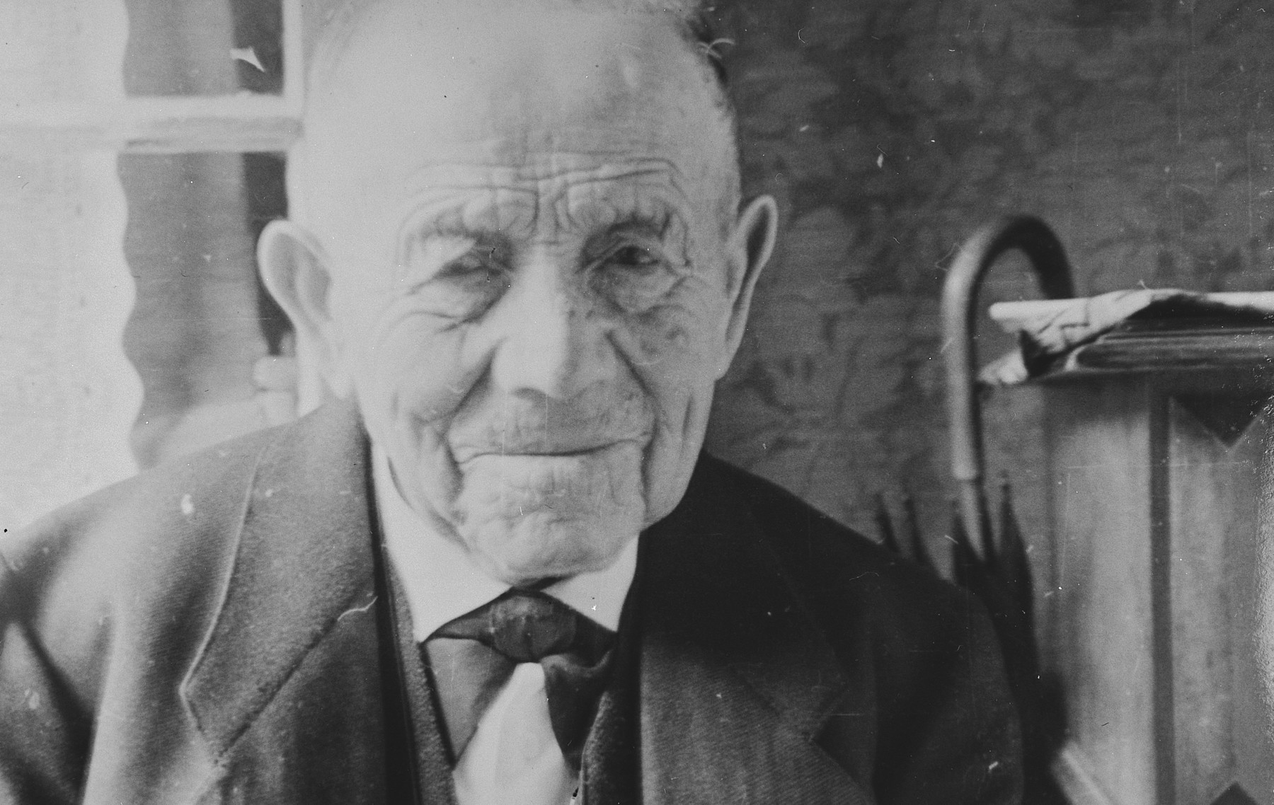 Close-up portrait of a Jewish man in Breisach, Germany.

Pictured is Leopold Geismar.  He was a cousin of the Bährs.  He died in the Jewish Home for the Elderly in Gailingen in July 1939.

This is part of series of photographs taken of the Breisach Jewish community on their way to and from synagogue in 1937.  In October 1940 the entire community was deported to the Gurs internment camp in southern France.