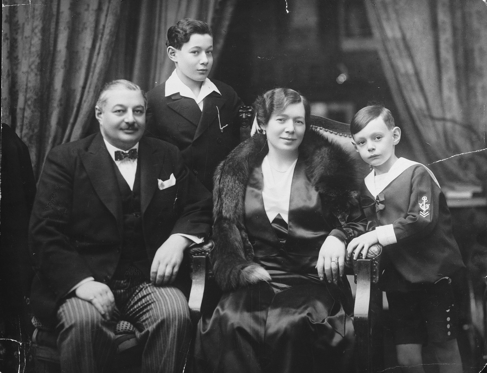 Studio portrait of a Hungarian-Jewish family.

Pictured from left to right are Zoltan, Paul, Iren and Robert Fisch.