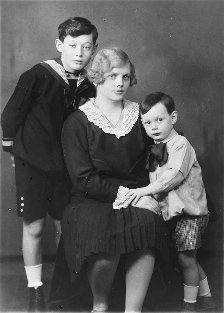 Studio portrait of two Hungarian-Jewish boys and their Hungarian nanny.

Pictured from left to right are Paul Fisch, Anna Tatrai and Robert Fisch.  Anna Tatrai later rescued the boys' mother and was recognized as Righteous Among the Nations.
