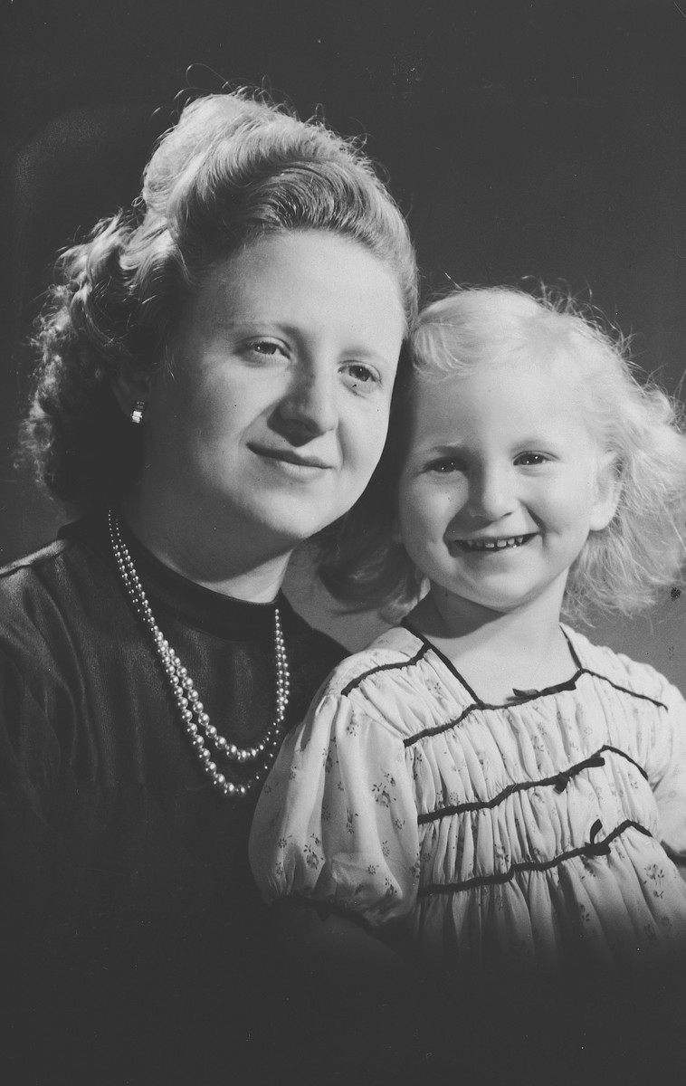 Studio portrait of a Belgian-Jewish mother and daughter taken shortly before they were forced to go into hiding.

Pictured are Fajga and Josiane Aizenberg.