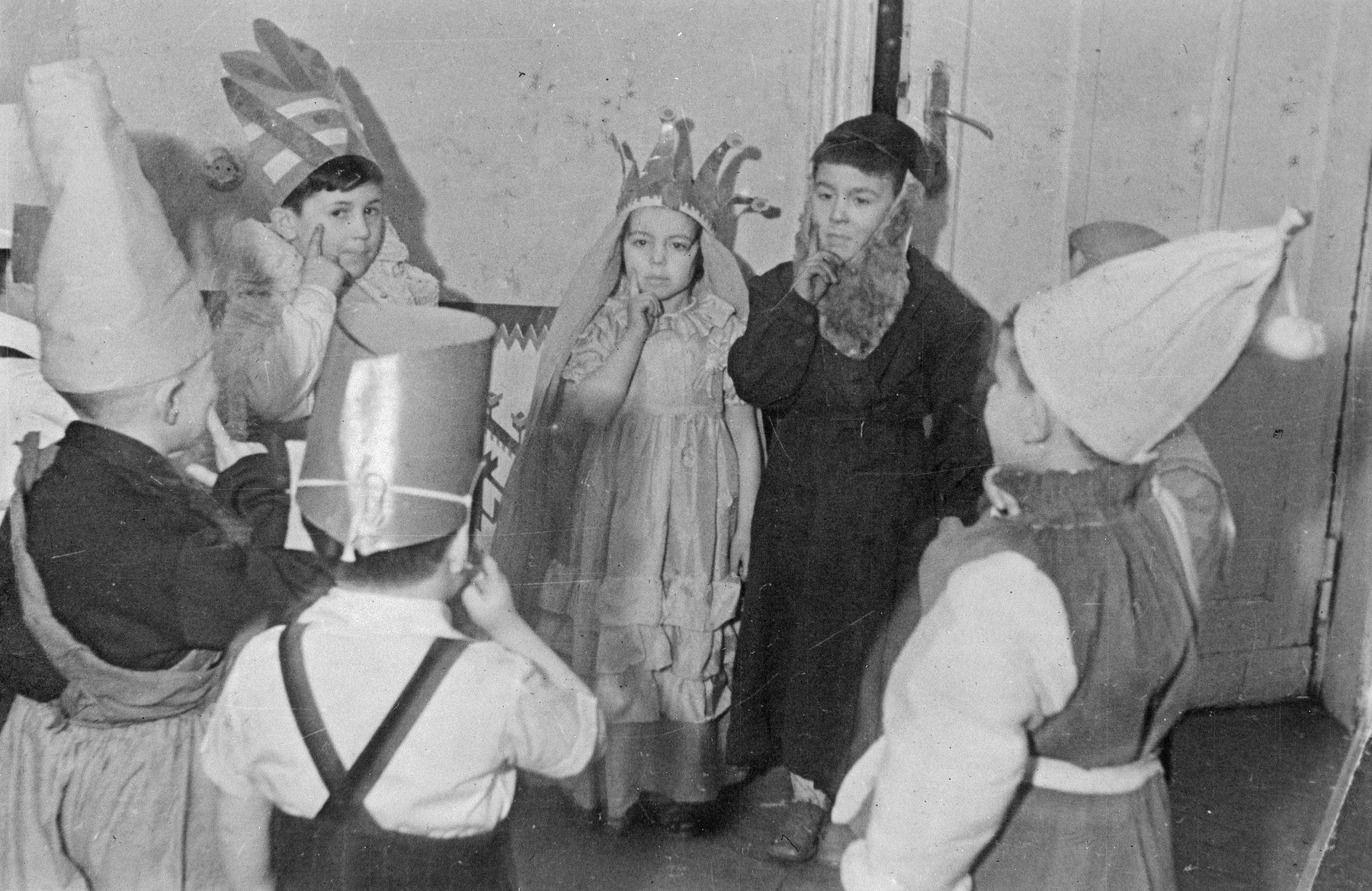 Children dressed in costumes from the Lodz Jewish kindergarten perform what is probably a Purim play.