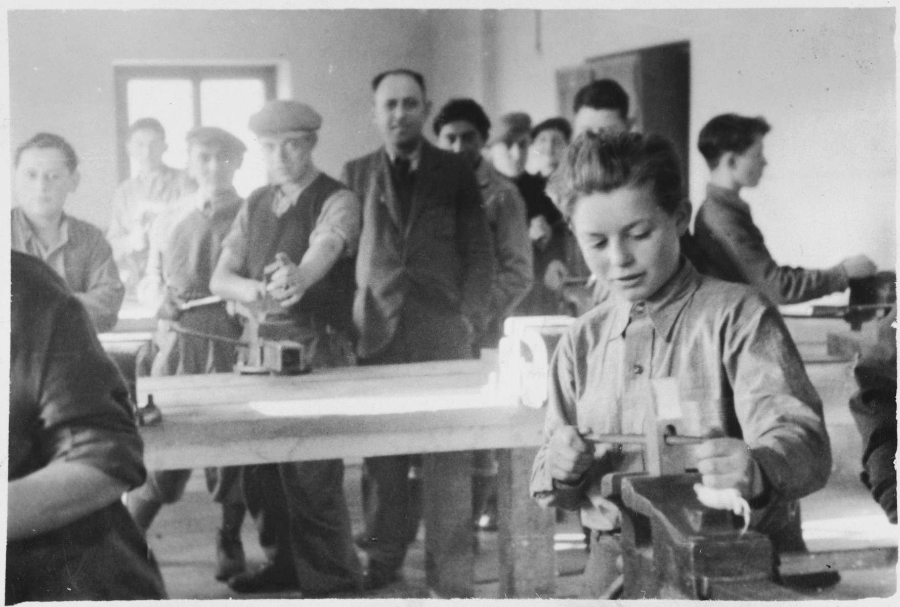 Jewish men and youth practice carpentry in a vocational workshop (probably in the Foehrenwald displaced persons camp).
