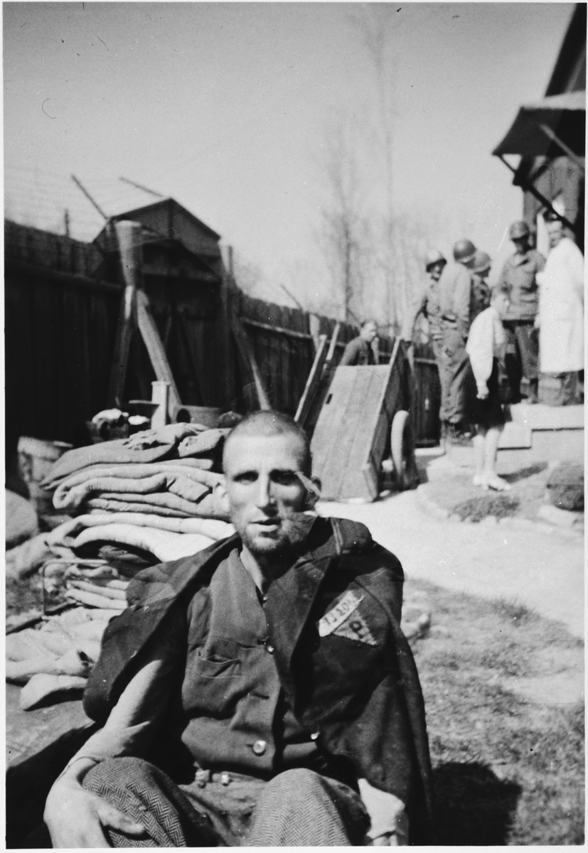 Close-up portrait of a survivor of the Buchenwald concentration camp.

The original caption reads, "This Russian inmate of the concentration camp was so weak that he was unable to stand for this picture."

[There is a bit of a discrepency with the caption by saying that the survivor was Russian.  His uniform has a triangle with a "P" for Pole.]