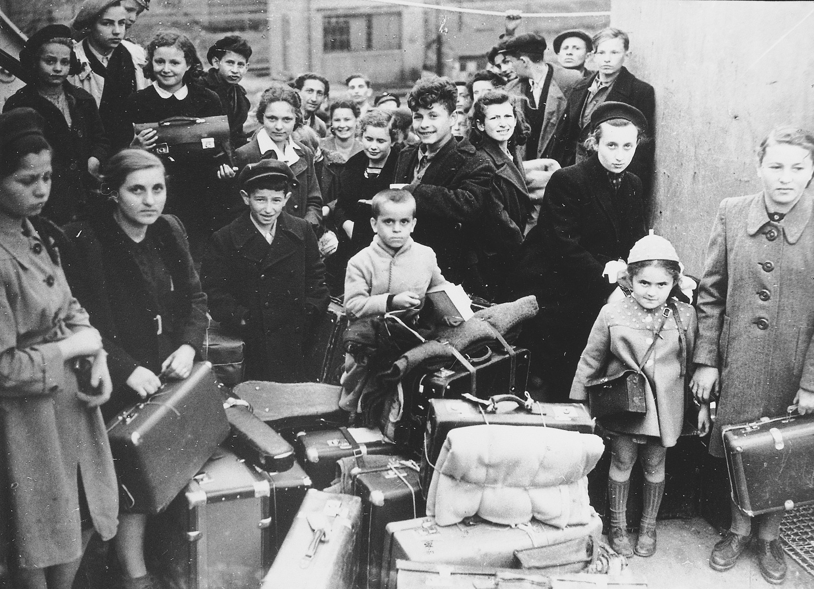 A group of child survivors arrives in Scotland by ship in a transport organized by Rabbi Solomon Schonfeld.

Approximately 200 children left on this transport organized with the support of the British Foreign Office.

Among those pictured are Elek Rebensztok (front center), Richard Vanger (directly behind Elek Rebensztok), Hannah Greenberg (top, third from left), and Jerzy Hoffman (top, fourth from left).