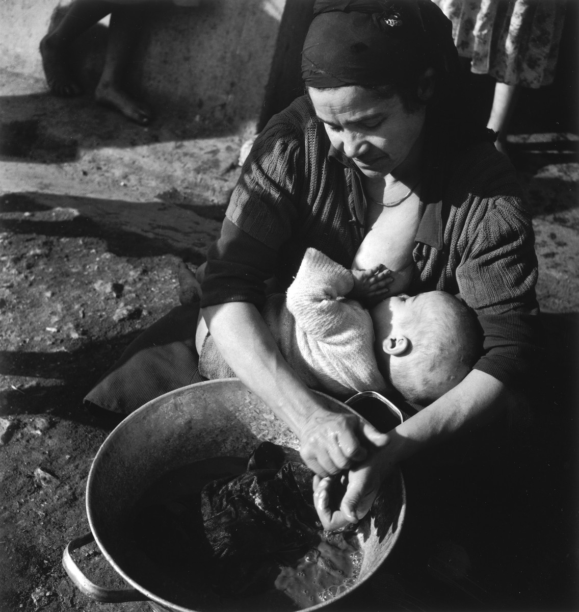 A young Morrocan-Jewish mother nurses her infant in the Los Arenas camp while waiting to immigrate to Palestine.