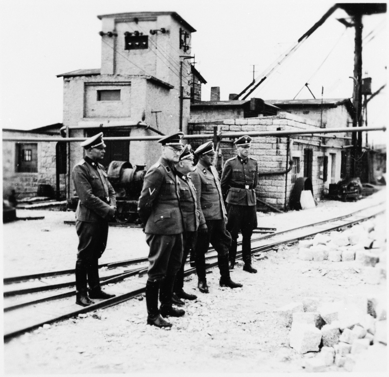 SS-Obergruppenfuehrer Ernst Schmauser visits the Gross-Rosen concentration camp's quarry with other SS officers.

Commandant Arthur Roedl is standing next to Schmauser in the center.