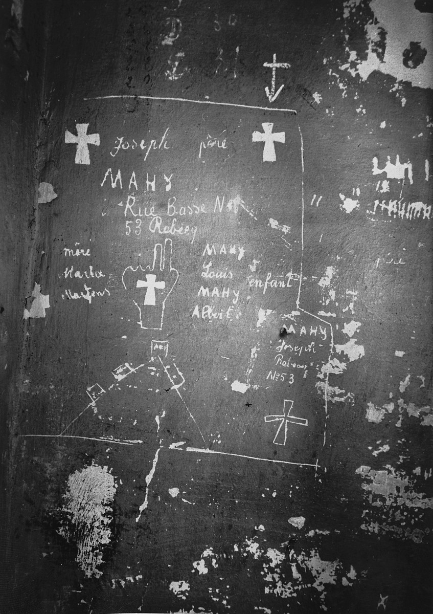 View of prisoner graffiti scratched on the walls of the Breendonck concentration camp.