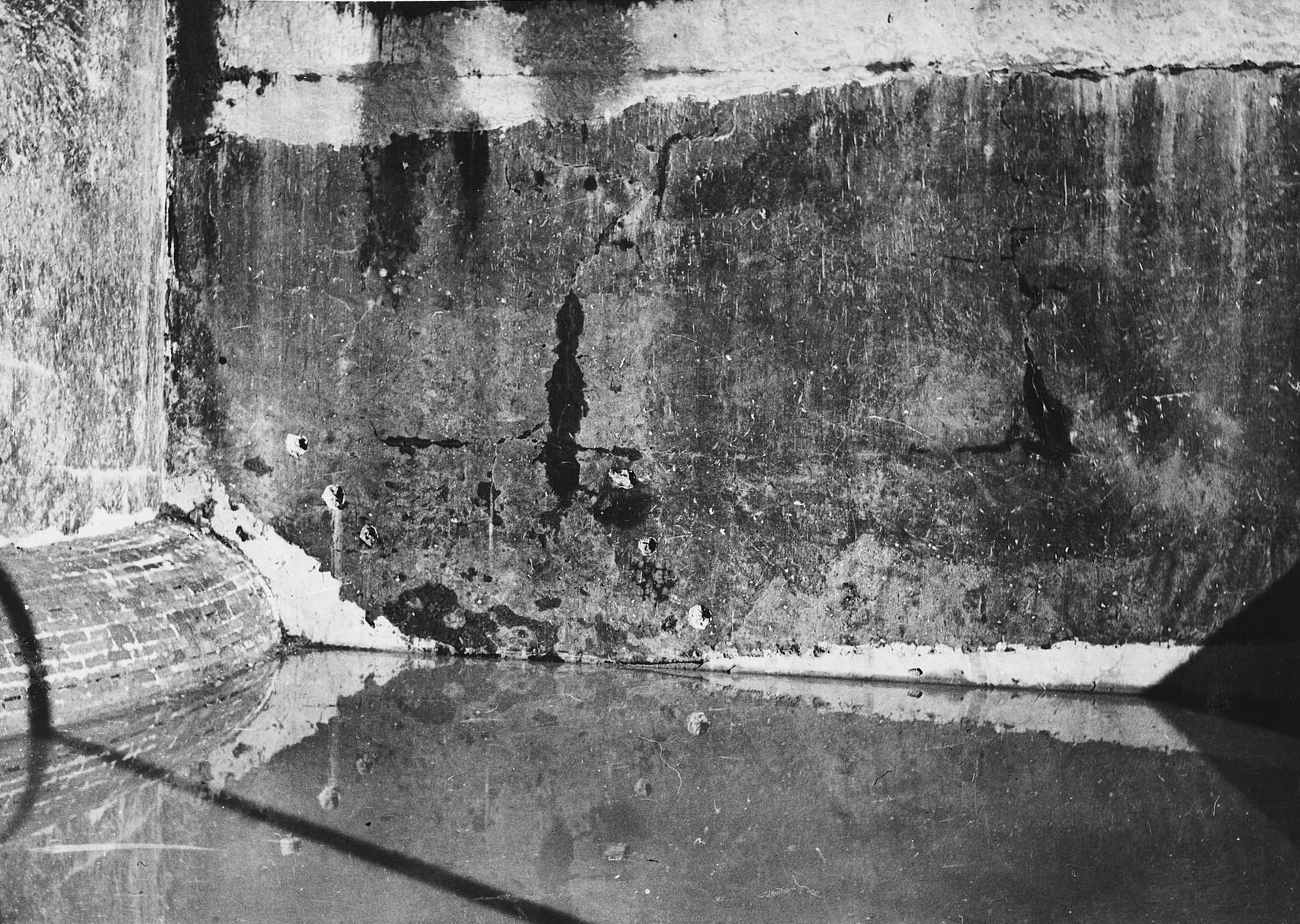 View of the execution site in the Breendonck concentration camp.  The wall in the rear of the execution posts shows bullet marks.