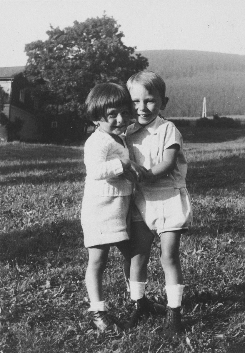 Two young children pose together on a grassy field.

Pictured on the left is Michael Grunbaum.