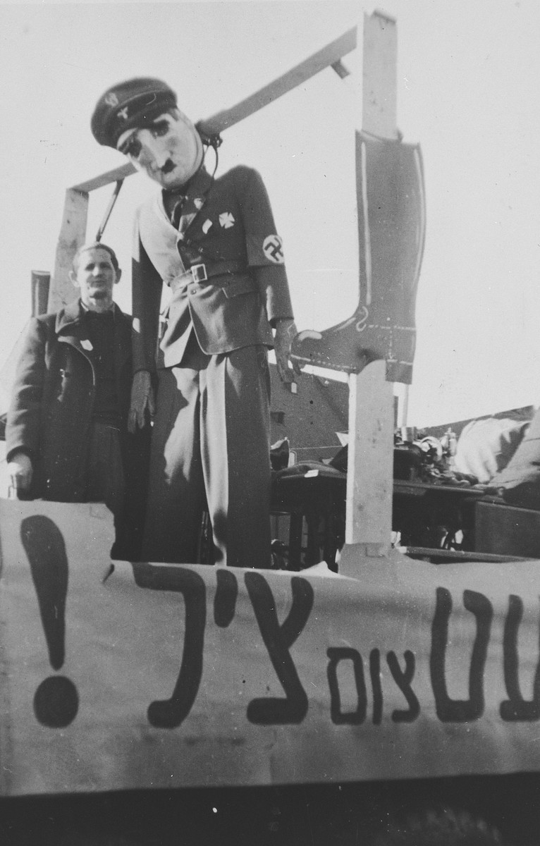An effigy of Adolf Hitler hangs in the Landsberg DP camp during [what is probably a Purim celebration].