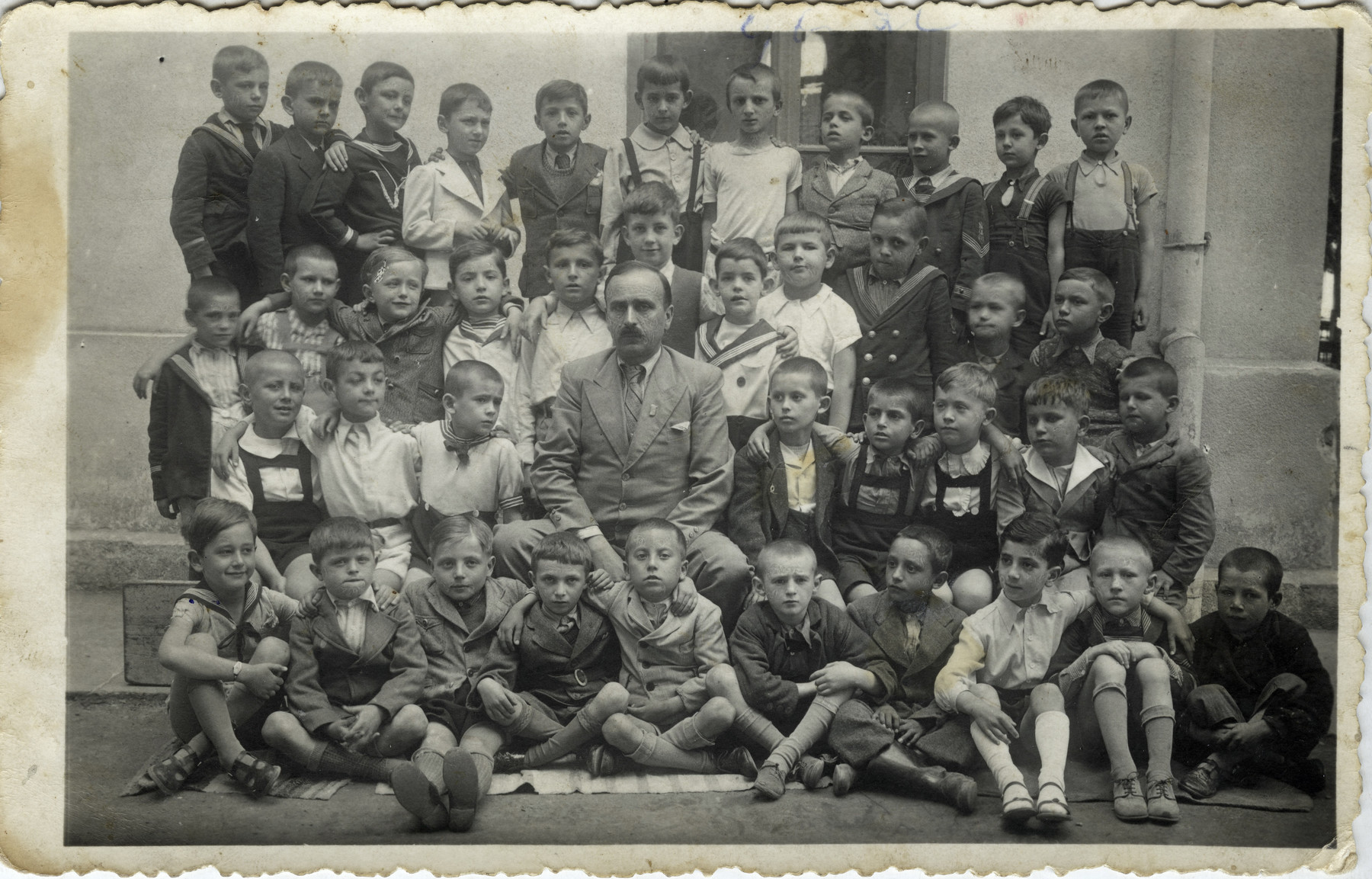 A picture of school children in Belgrade prior to the war. 

Joseph (third from the right in the front row) is pictured along with his classmates and teacher who was heroic and would not let Germans know which children were Jewish.