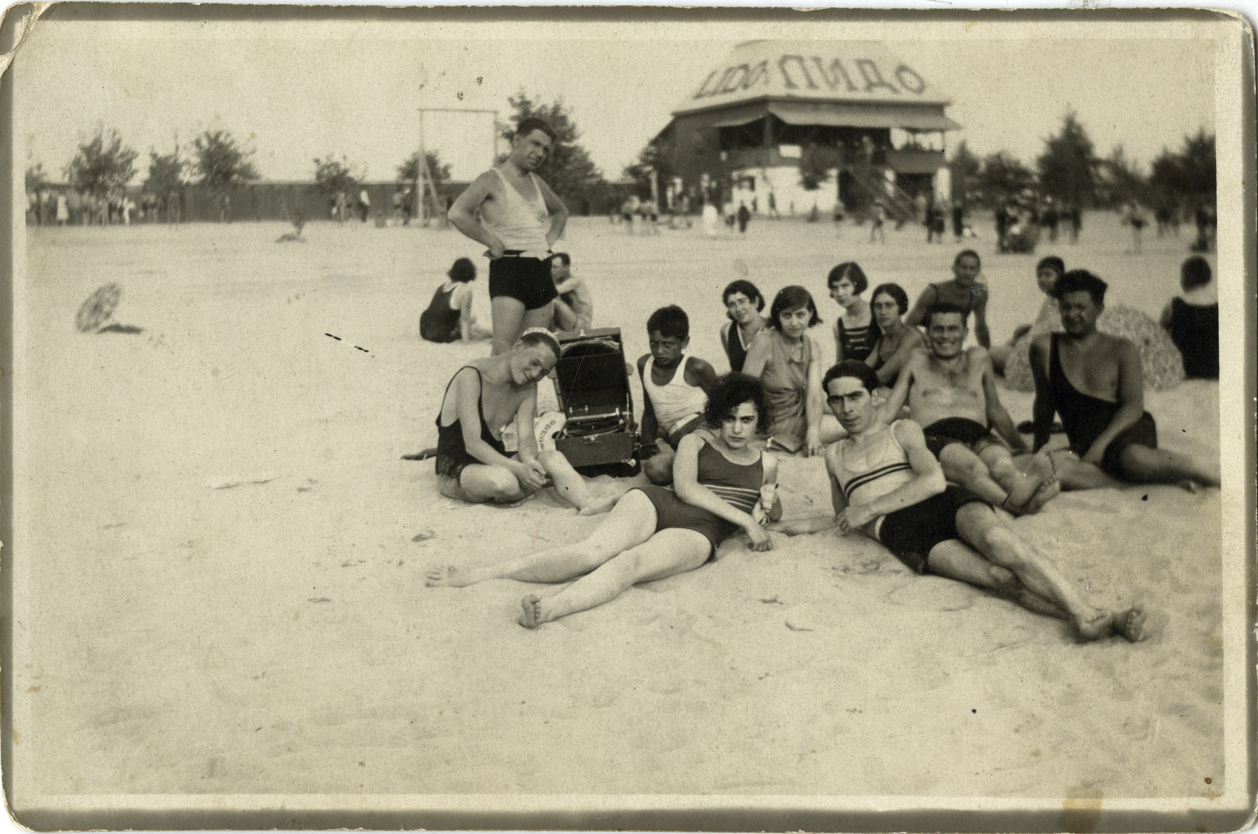 A group of Yugoslavs relax on a beach in Belgrade.

Yitzhak (Izak) Manojlvic (first row on the right) on the beach with future wife Hilda Gerstel (first row on the left) in front of Lido, Belgrade.