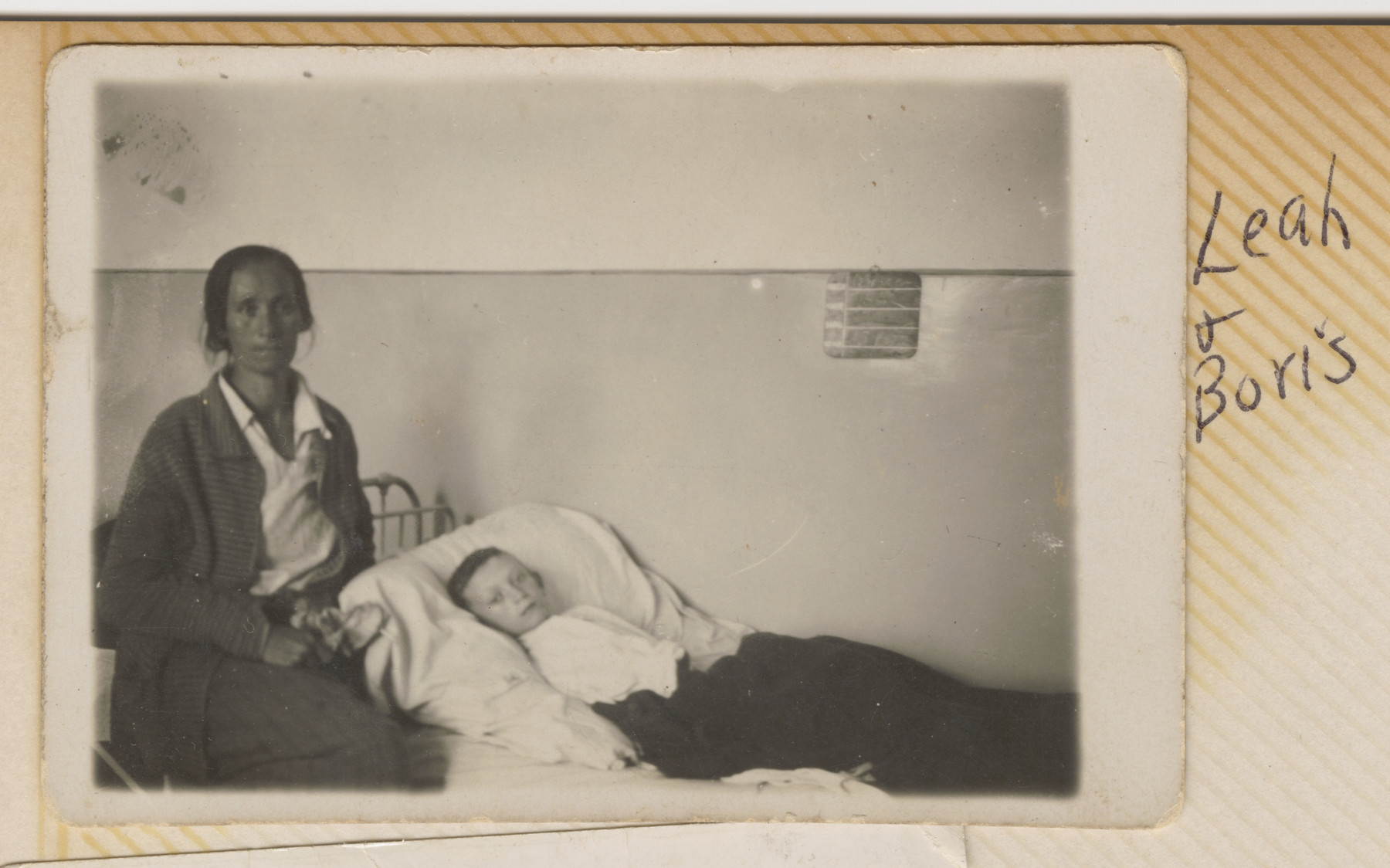 Leah Szwarcman nurses her son Boris who is lying in bed.