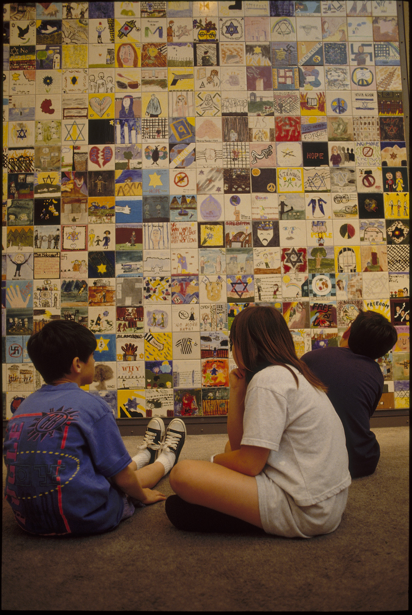 Children view the Tile Wall on the concourse of the U.S. Holocaust Memorial Museum.