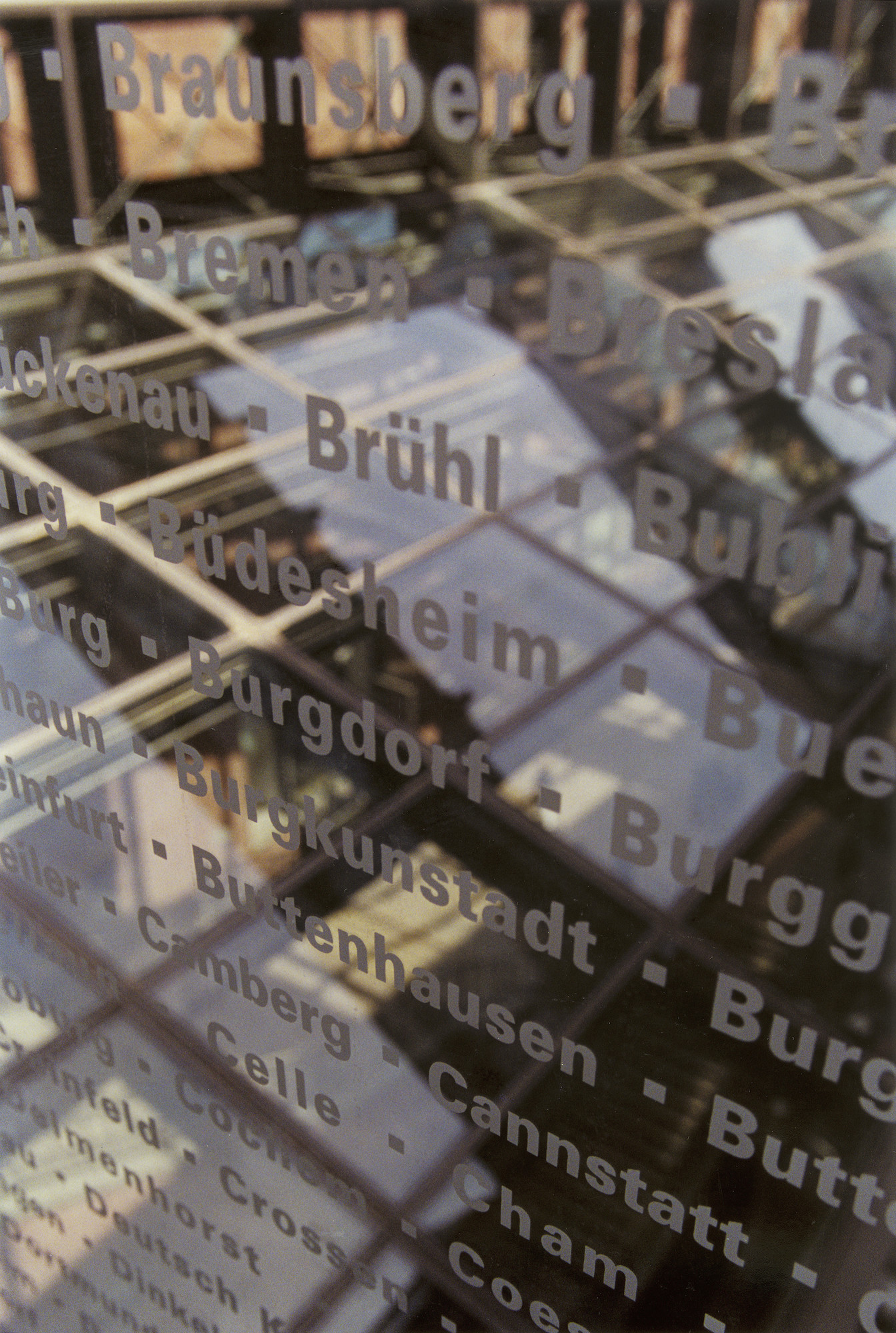 Interior of one of the glass bridges in the permanent exhibition of the U.S. Holocaust Memorial Museum, etched with the names of communities that were destroyed during the Holocaust.