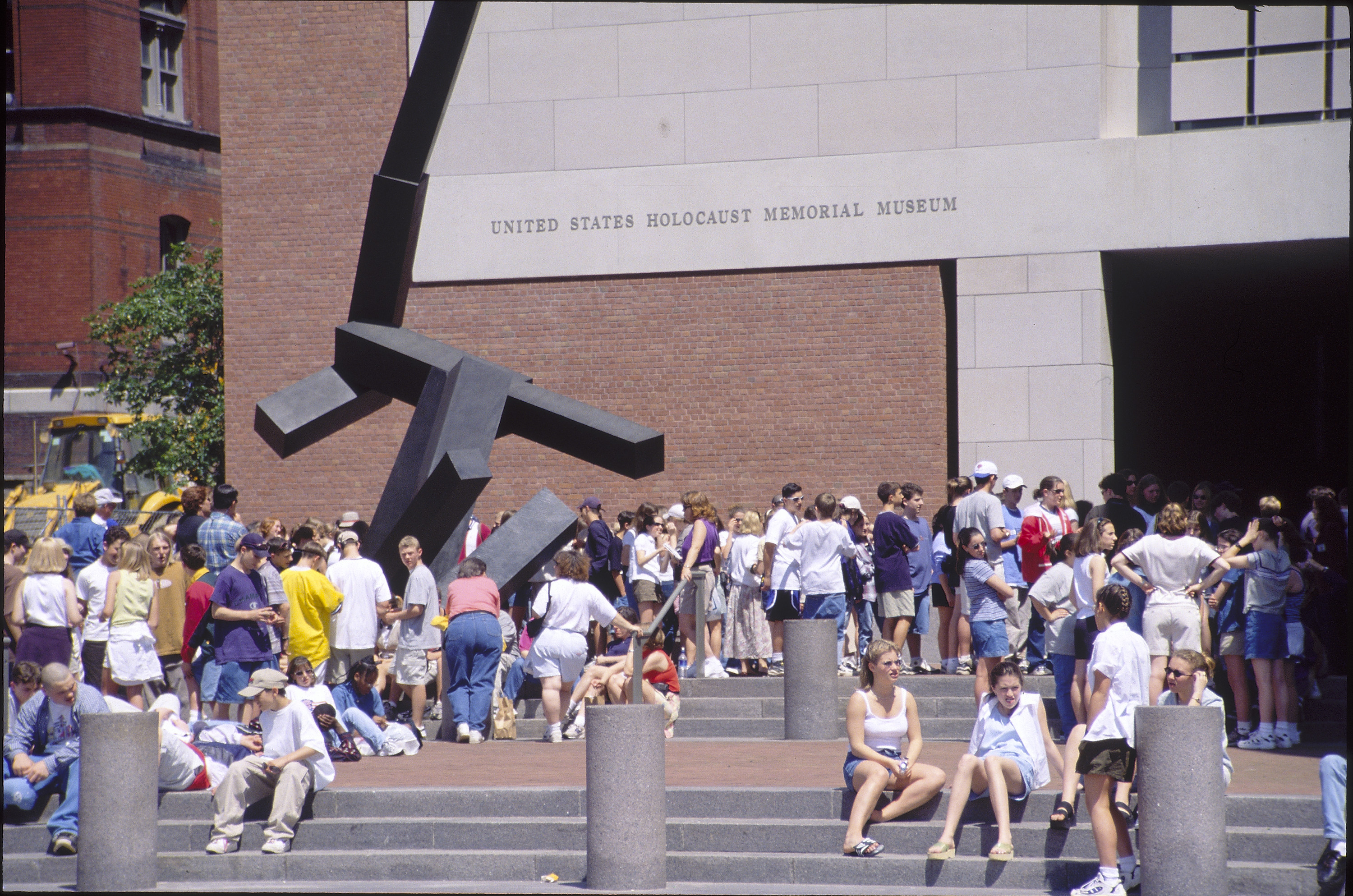 Visitors wait outside the 15th Street entrance to the U.S. Holocaust Memorial Museum.