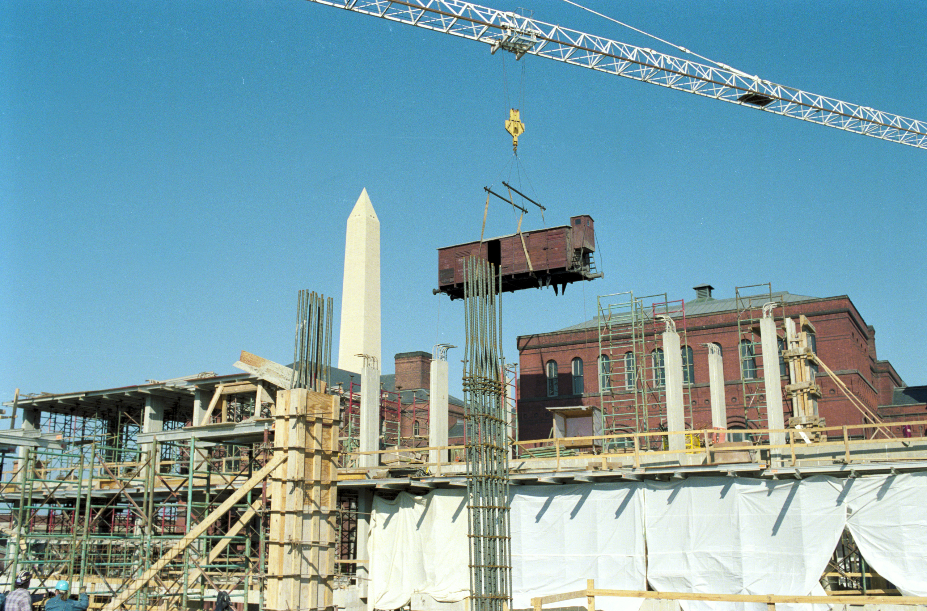 Installation of the railcar at the construction site of the U.S. Holocaust Memorial Museum.