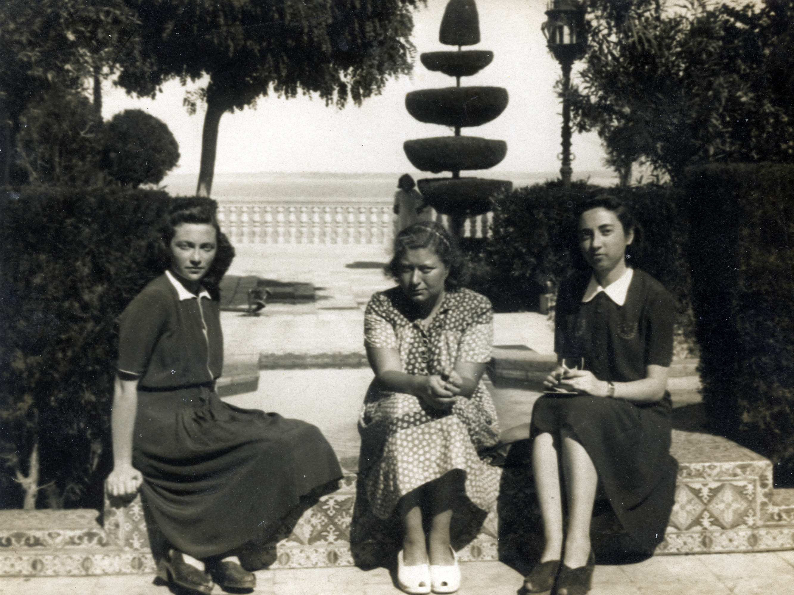 Young women rest in a park en route to Palestine.

Among those pictured is Jenny Ezratty on the left,