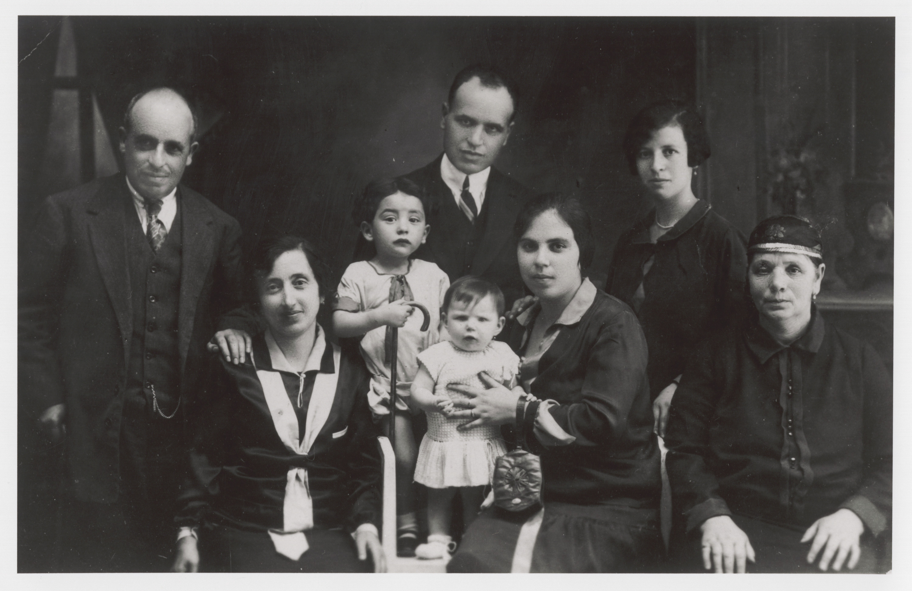 Portrait of a Jewish family in Monastir (Bitola).

Among those pictured are (standing in back, left to right) Mr. Shami and Mr. Shami (brothers), and [an unidentified woman]; (seated, left to right) the sister of Mrs. Mayo (who was a cousin of Avram Nahmias), [an unidentifed child], Allegra ("Gita"), Sara Shami (sister of Rachel Nahmias' brother-in-law, Samuel Levy), and "Grandma" Shami.