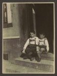Brothers Helmut and Erich Rosendahl sit on the steps of the house where their father was born, in Gangelt, Germany.