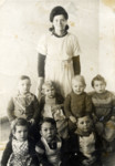 A group of toddlers and their caretaker at the Bergen-Belsen displaced persons camp.