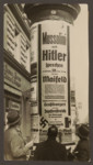 Pedestrians gather around a poster advertising joint speeches to be held by Hitler and Mussolini in Berlin.