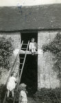 Three children, two of them Jewish children in hiding, play together by a ladder.