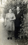 A Polish Jewish couple outside their house in the Heidenheim displaced persons camp.